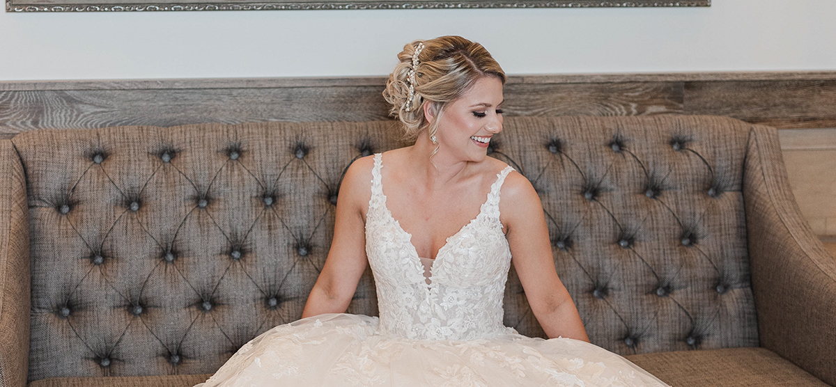 Bride sitting on a couch in the dressing room at SentryWorld