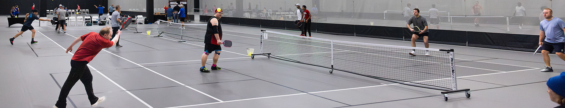Games of pickleball being played in the SentryWorld field house.