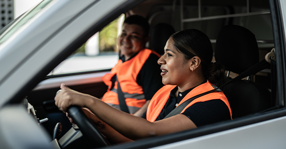 two drivers in van wearing high vis