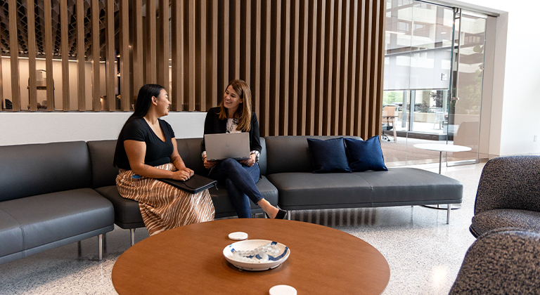 Two people talking in the Sentry corporate office lobby