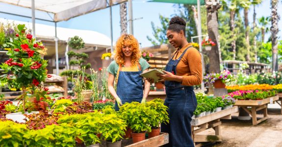 two women working outdoors at garden center