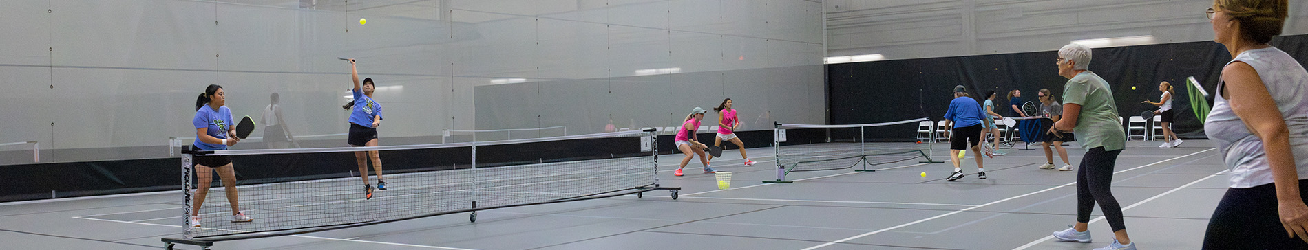 Games of pickleball being played in the SentryWorld field house.