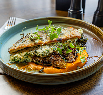 Stuffed Trout with crab cream cheese stuffing, spicy carrot puree, roasted Brussels sprouts, and microgreens.