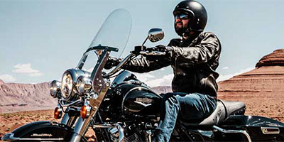 Man riding motorcycle in a desert area