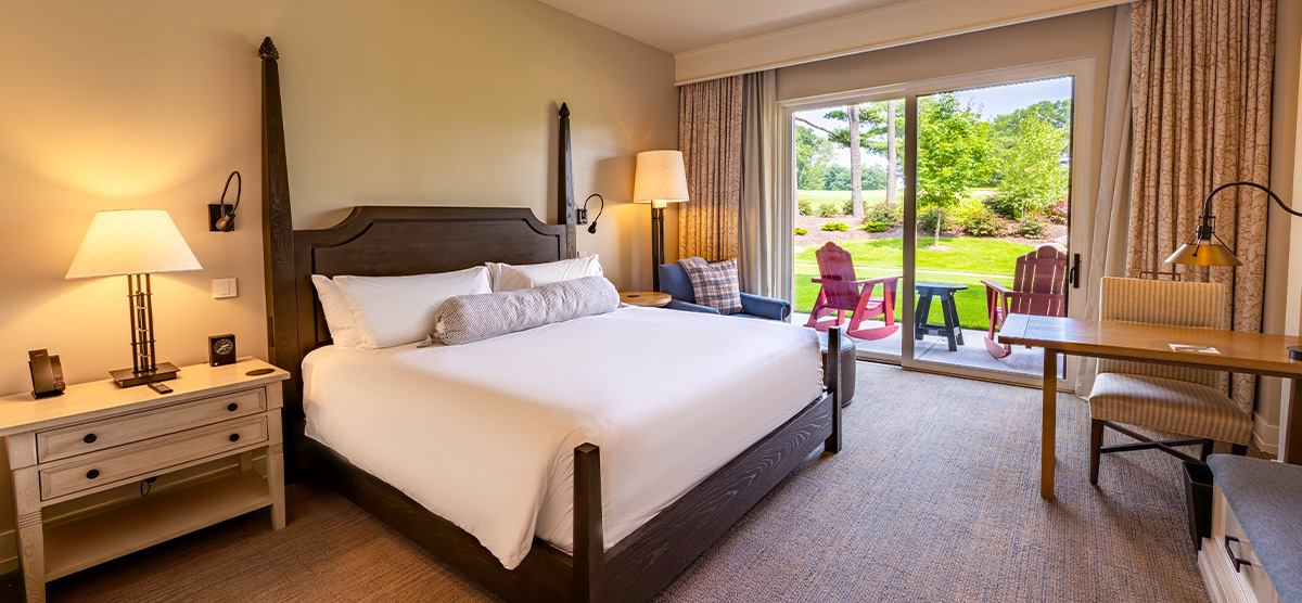 carousel-golf-view-king-terrace-1-1200x556 King bed with patio door overlooking the golf course.