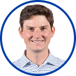 Headshot of a man smiling in a blue and white striped shirt.