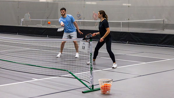 Pickleball team playing in the SentryWorld fieldhouse. 