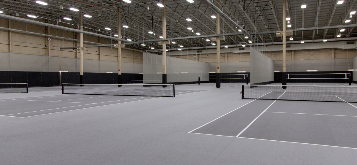 SentryWorld fieldhouse with multiple pickleball courts with dividers. 