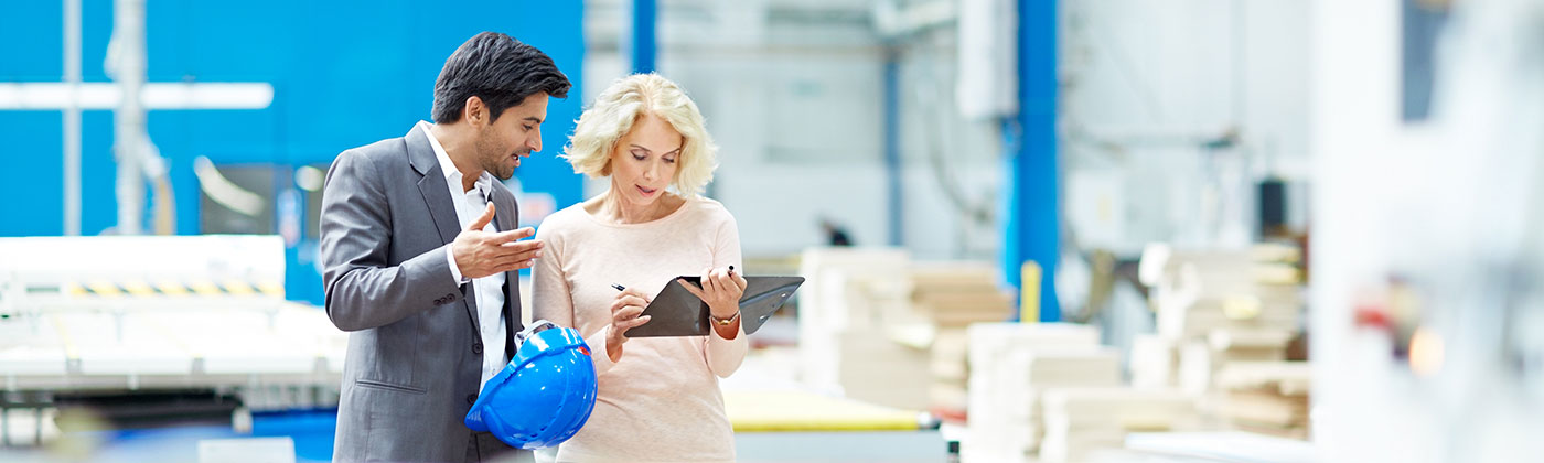 Man and woman talking in factory