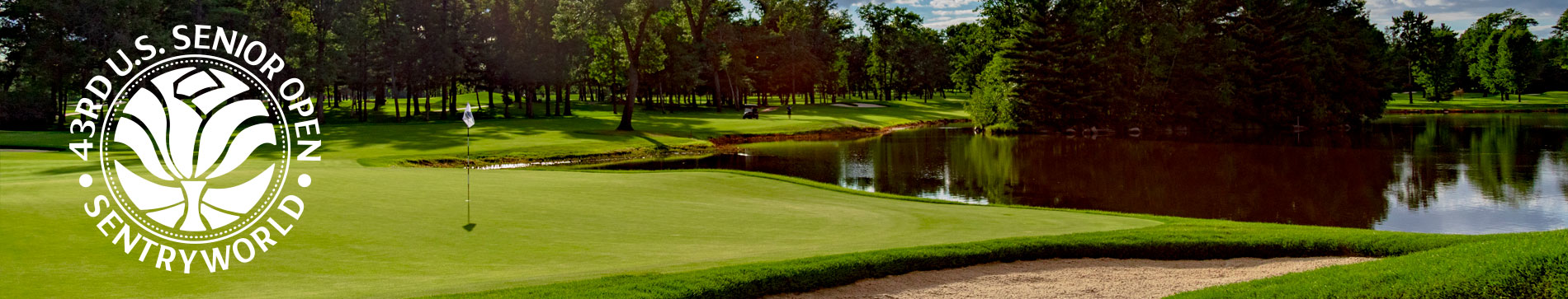 Putting green next to a water hazard and sand trap with the U.S. Senior Open at SentryWorld logo