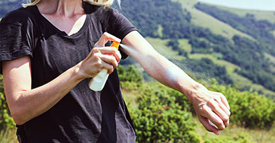 Woman putting on sunscreen