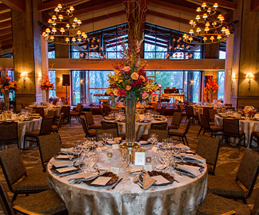 Tables set with floral decor in the Grand Hall at SentryWorld