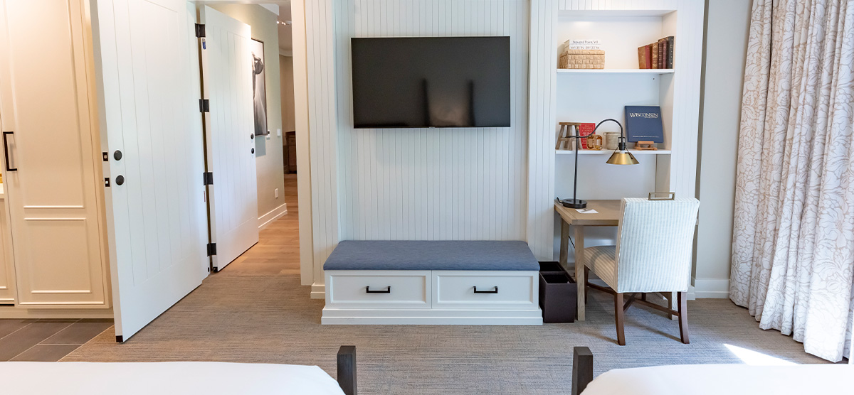 carousel-suite-golf-view-king-queen-5-1200x556 Queen room overlooking desk and doorway to parlor area.