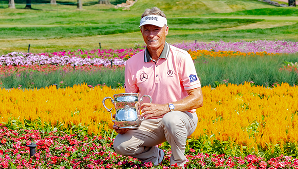 Bernhard Langer posing with the U.S. Senior Open trophy at SentryWorld