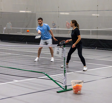 People playing pickleball in the fieldhouse at SentryWorld