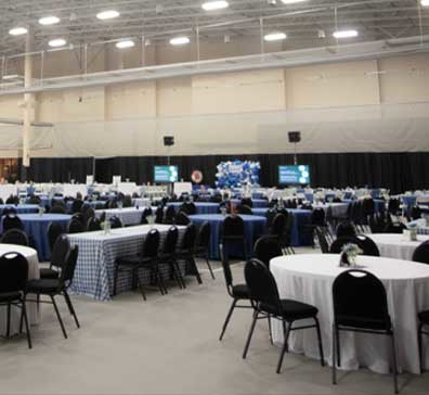 Tables set in the fieldhouse at SentryWorld for an event