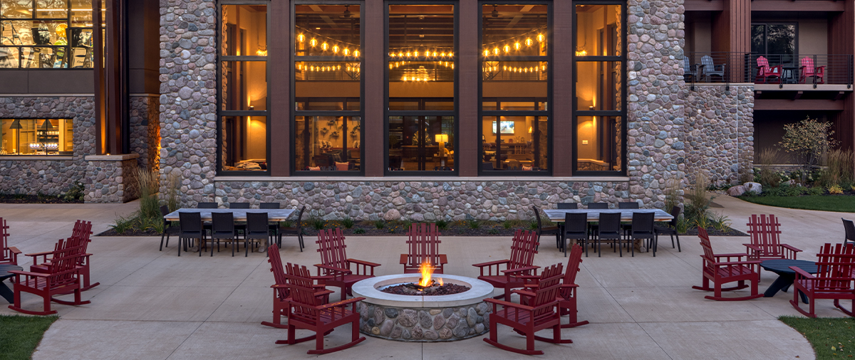 Seating around the fireplace behind The Inn at SentryWorld