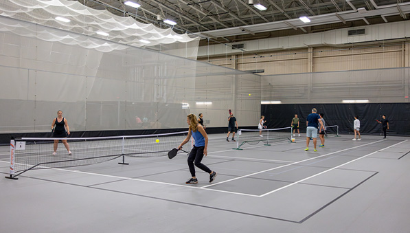 People playing pickleball in the fieldhouse at SentryWorld