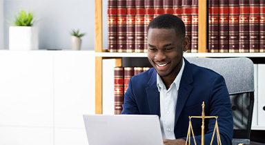 A legal associate working on a computer.