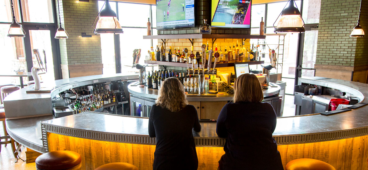 Two people sitting at the PJ's bar