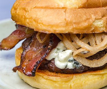 Hamburger with bacon, onion strings, and cheese at PJ's