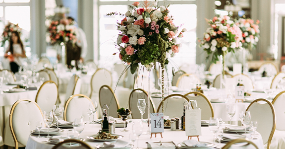 Tables decorated with floral arrangements for a wedding reception