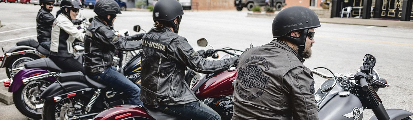 Men and women riding Harley Davidson motorcycles