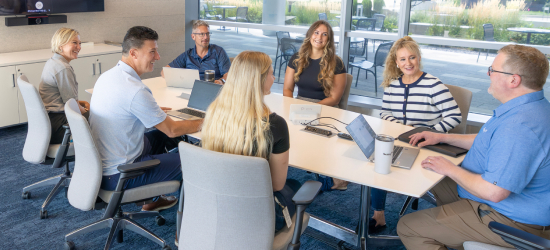 Group of associates working together at a conference table.