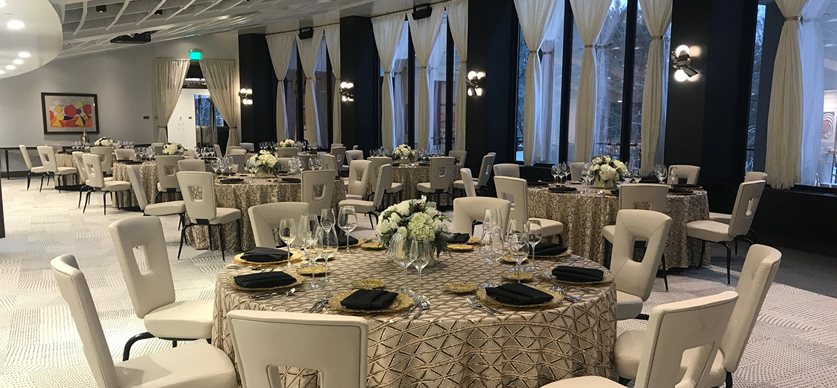 carousel-wedding-venue-muse-gallery-room-1-1200x556 Round tables with chairs set up in the Muse gallery room.