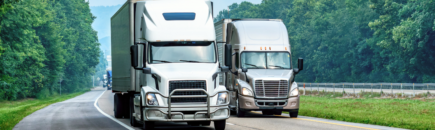 Two semi trucks on an interstate.