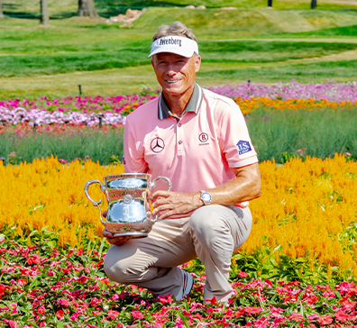 Bernhard Langer posing with the U.S. Senior Open trophy at SentryWorld