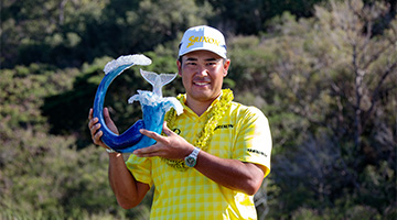 Hideki Matsuyama holding The Sentry trophy after his 2025 win.