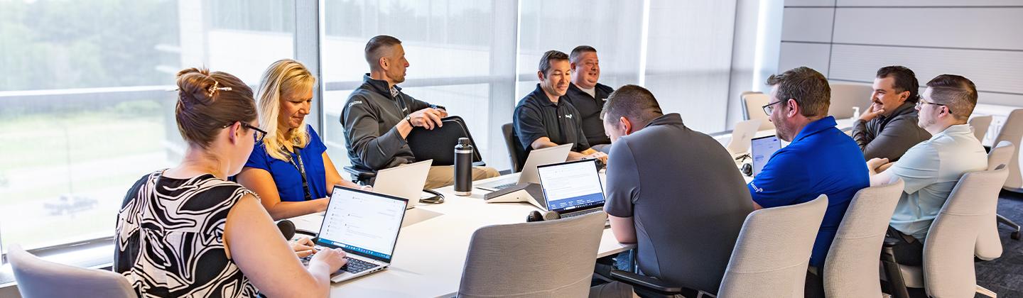 group of people working together at a table in an office setting