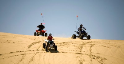 ATV riders on sand dunes