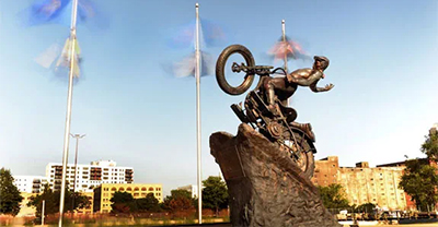 Motorcycle statue climbing a hill