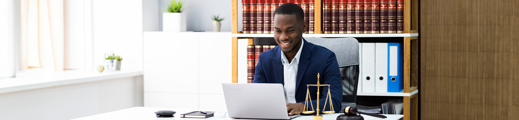 A legal associate working on a computer.