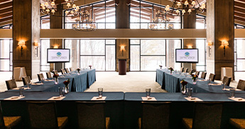 U-shaped table set up facing the wall of windows in the Grand Hall at SentryWorld