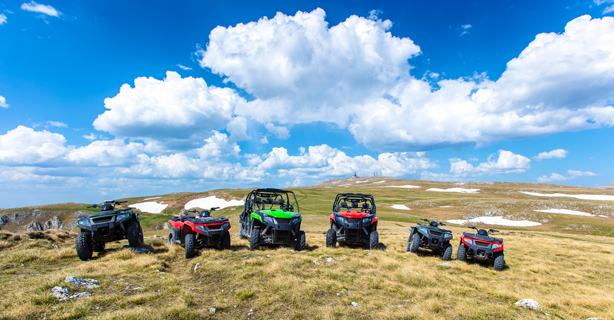 Line of ATVs and UTVs in a valley