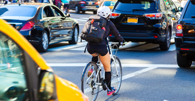 Woman on bicycle in traffic