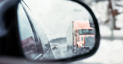 View of a semi from a side-car mirror