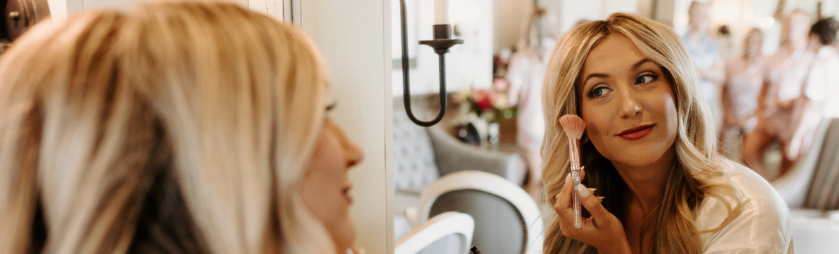 Woman putting on make-up in the SentryWorld salon room. 