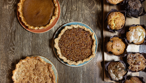 50-50-holiday-bakery-callout-597x339 Pie and muffins on a table.