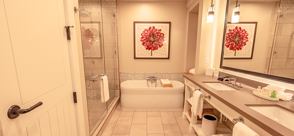 carousel-golf-view-executive-level-luxury-junior-suite-5-1200x556 Bathroom with two sinks, tub, and glass shower area.