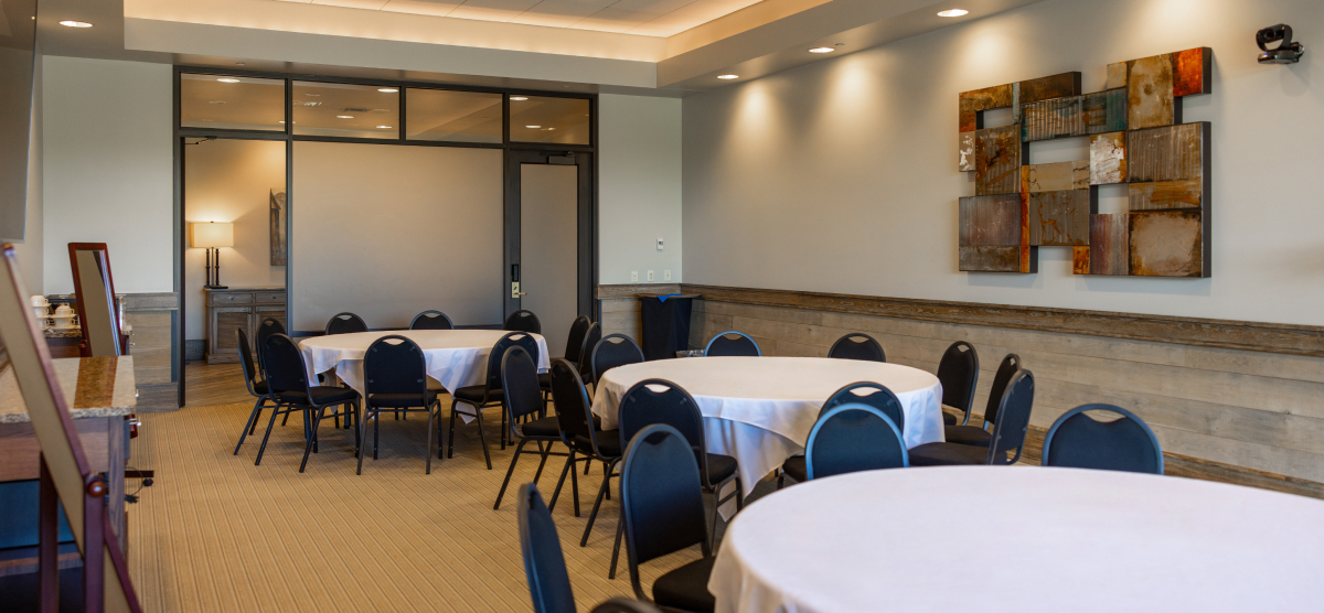 Three round tables with chairs and mirrors for getting ready. 