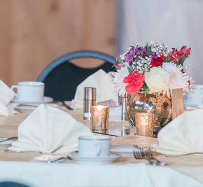 Floral centerpiece and table settings for a wedding