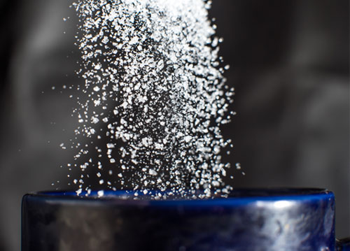 Sugar pouring into mug