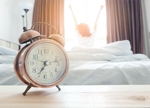 Lady waking up to alarm clock