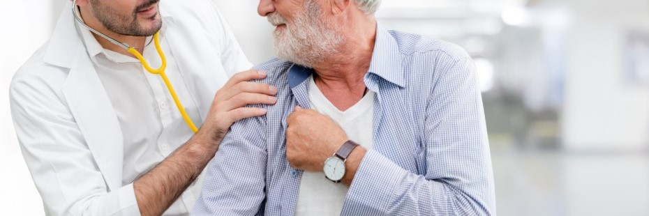 Young male doctor with older male patient