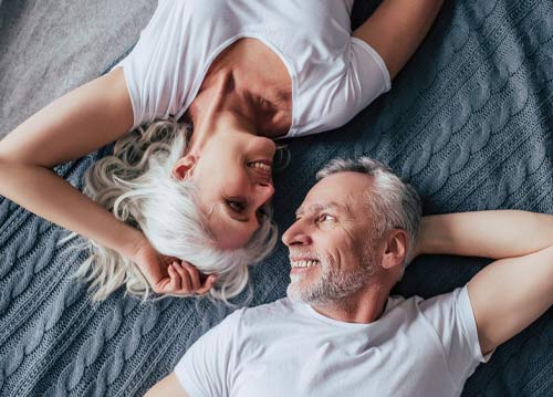 Happy couple laying down