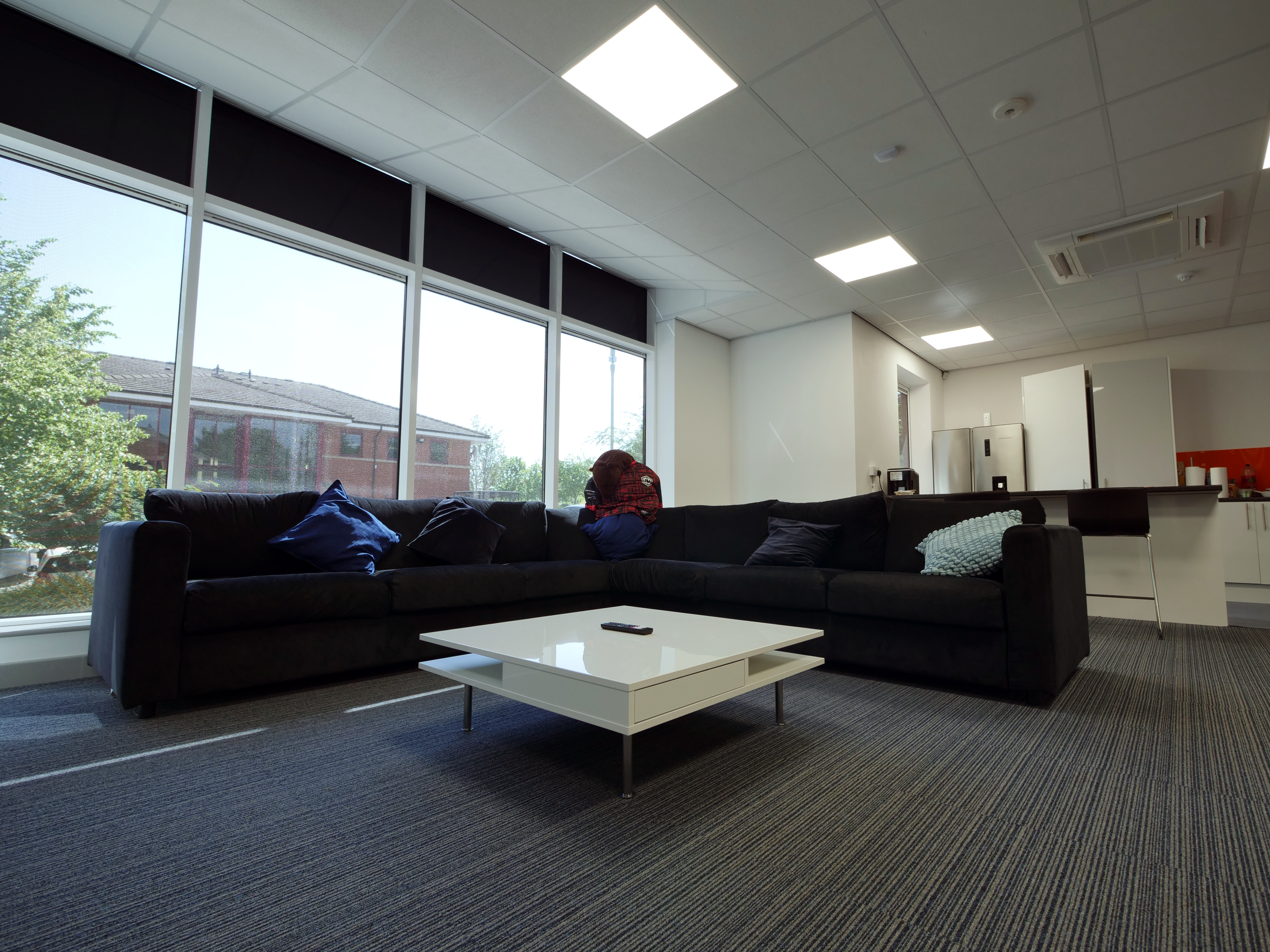 Lounge with sofas and a large smart TV at Endpoint HQ